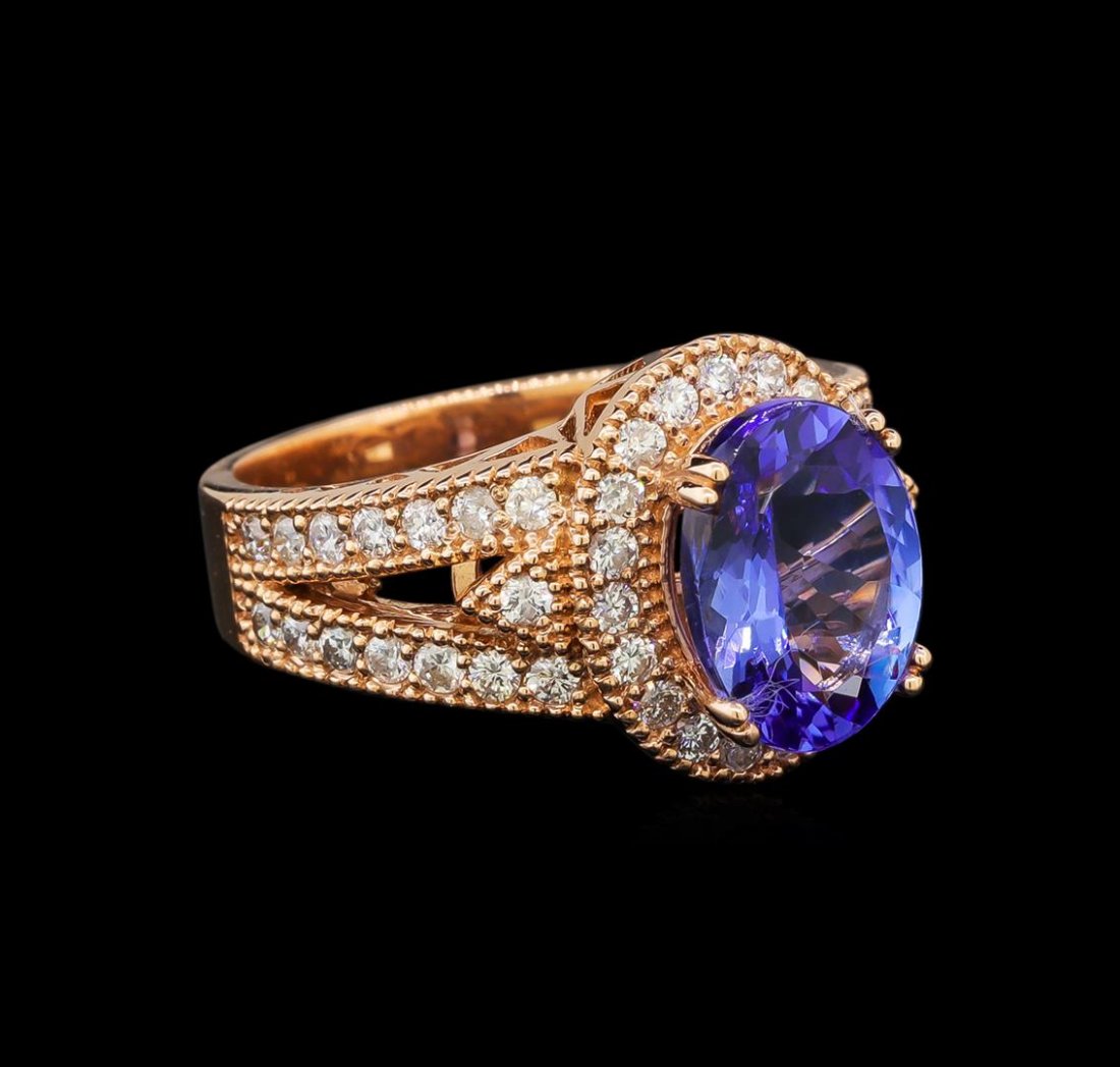 14KT Rose Gold 3.16 ctw Tanzanite and Diamond Ring: One electronically tested 14KT rose gold ladies cast tanzanite and diamond ring with a bright polish finish. Identified with markings of "K14". Condition is new. Containing: One prong set oval modifie