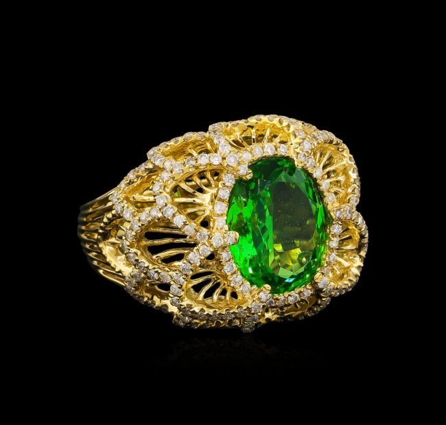 3.67 ctw Tsavorite and Diamond Ring - 14KT Yellow Gold: One electronically tested 14KT yellow gold lady's cast fancy ring with a tapered shank with a bright polish finish. The featured lady's ring has a scalloped floral motif and a shank measuring 3.50 mil