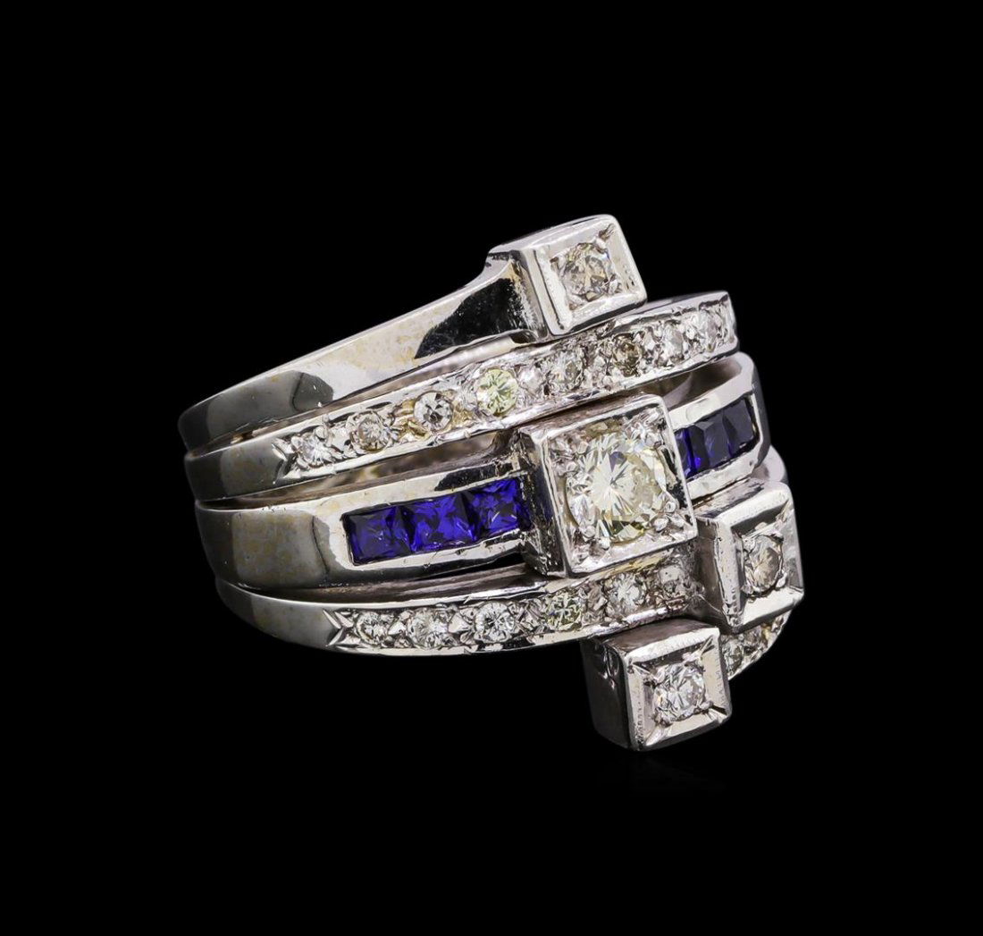 0.82 ctw Diamond and Sapphire Stackable Ring Set - 14KT: One electronically tested 14KT white gold ladies cast & assembled diamond and laboratory created sapphire stackable rings. The set contains three separate rings. The center ring features a diamond sup