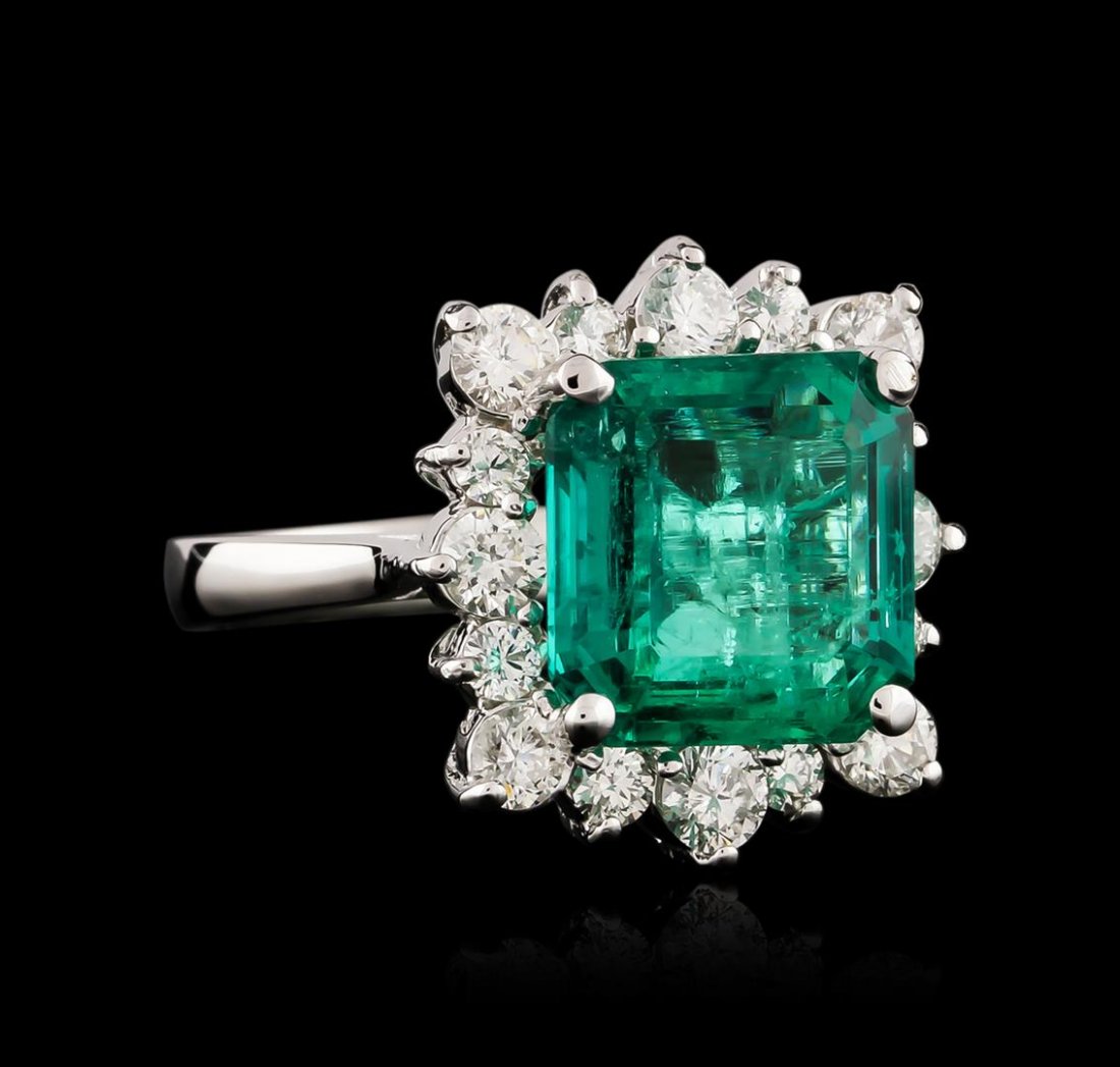14KT White Gold GIA Certified 6.41 ctw Emerald and: One electronically tested 14KT white gold ladies cast emerald and diamond ring with a bright polish finish. Identified with markings of "14K". Condition is new. Containing: One prong set emerald stand