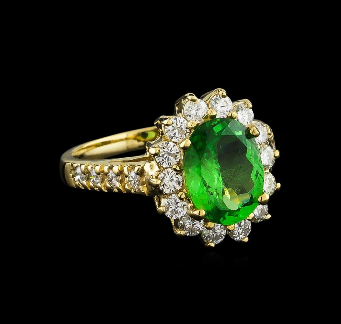 2.32 ctw Tsavorite Garnet and Diamond Ring - 14KT: One electronically tested 14KT yellow gold ladies cast tsavorite garnet and diamond ring with a bright polish finish. The featured tsavorite garnet is set within a diamond bezel supported by diamond s