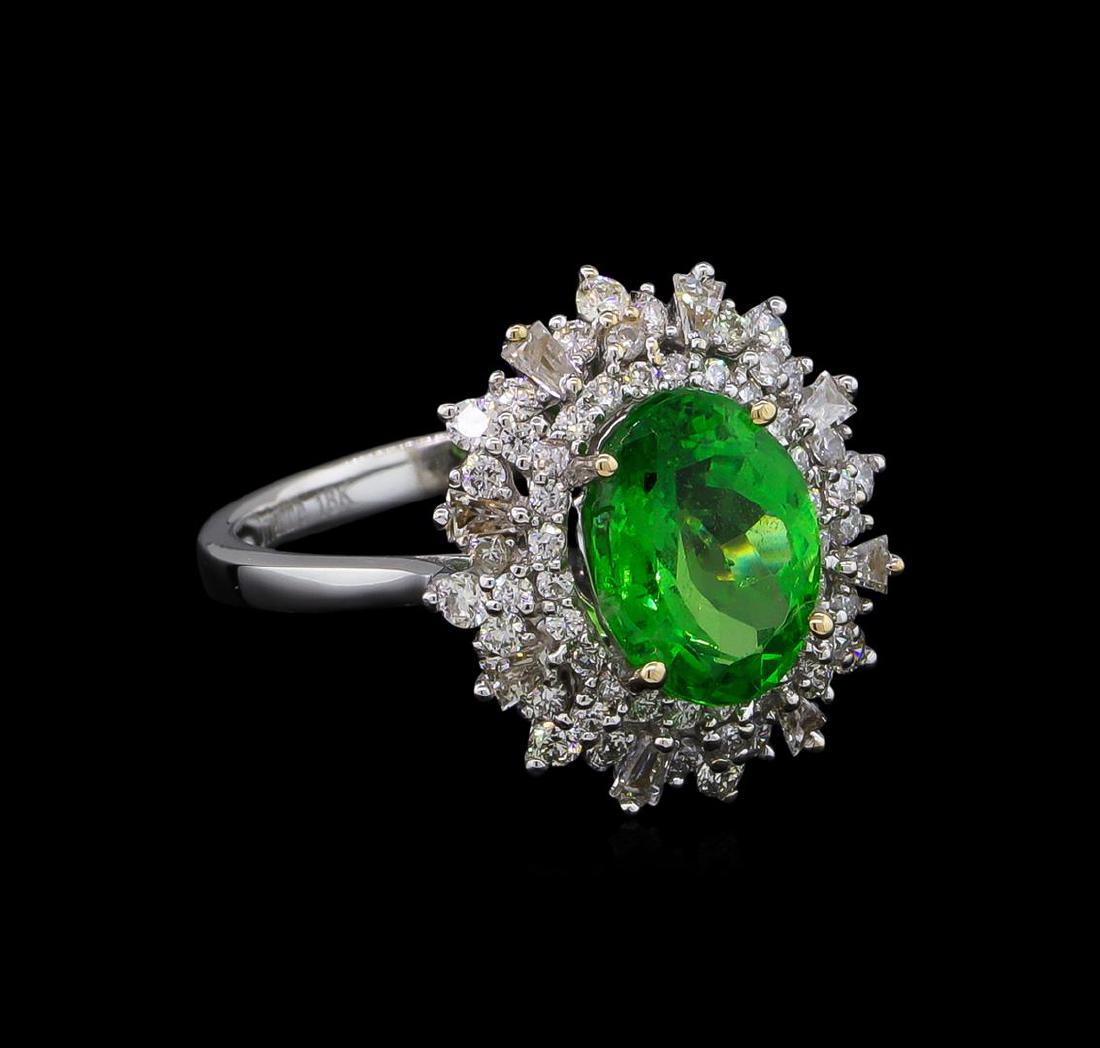 2.68 ctw Tsavorite and Diamond Ring - 18KT White Gold: One electronically tested 18KT white gold lady's cast fashion ring with a triple basket halo with a bright polish finish. The featured lady's ring has a shank measuring 2.07 millimeters wide. Trademar