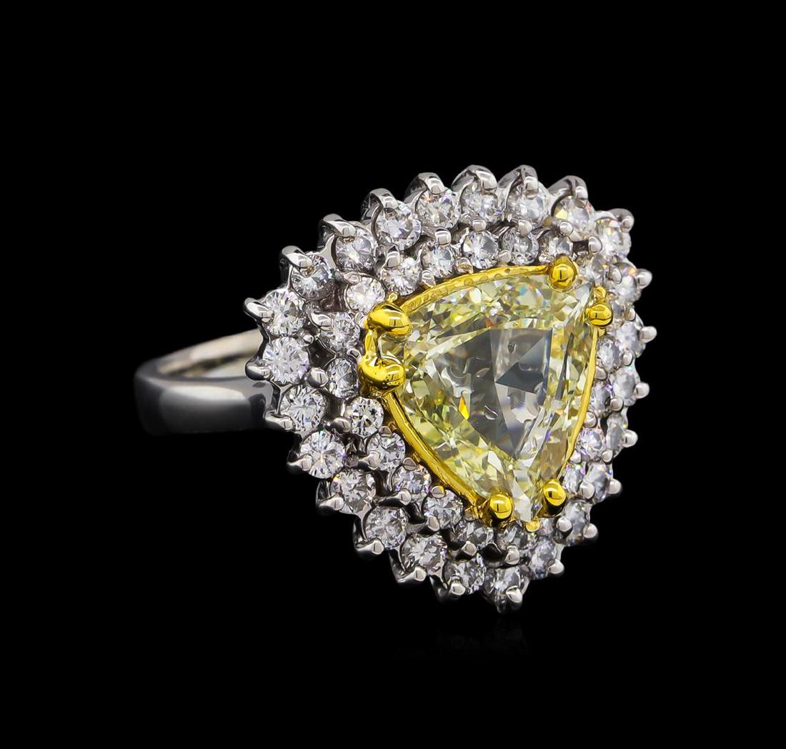 3.65 ctw Light Yellow Diamond Ring - 14KT White Gold: One electronically tested 14KT white gold ladies cast diamond ring. The featured diamond is set within tiered diamond bezels supported by a ribbed under gallery, completed by a two and one-half millim