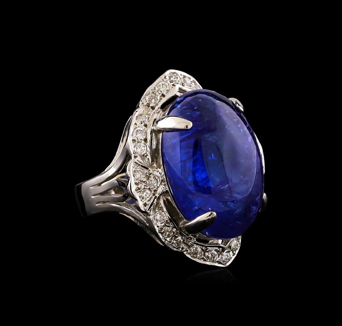 14KT White Gold 13.23 ctw Tanzanite and Diamond Ring: One electronically tested 14KT white gold ladies combination cast & assembled ring with a bright polish finish. Condition is new. Identified with markings of "14K". Containing: One prong set oval cabo