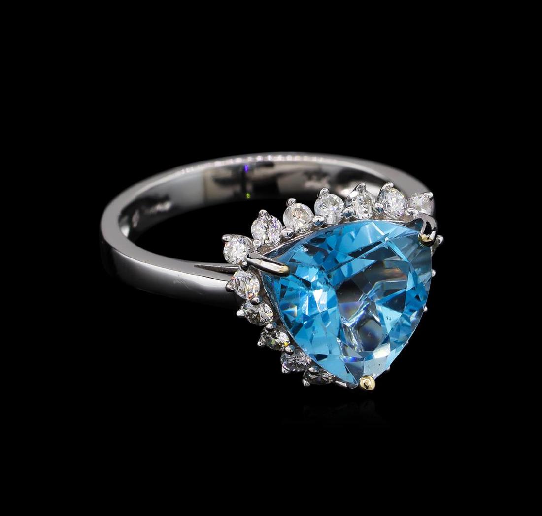 14KT White Gold 4.47 ctw Blue Topaz and Diamond Ring: One electronically tested 14KT white gold ladies cast blue topaz and diamond ring with a bright polish finish. Condition is new, good workmanship. The featured topaz is set within a diamond bezel supp