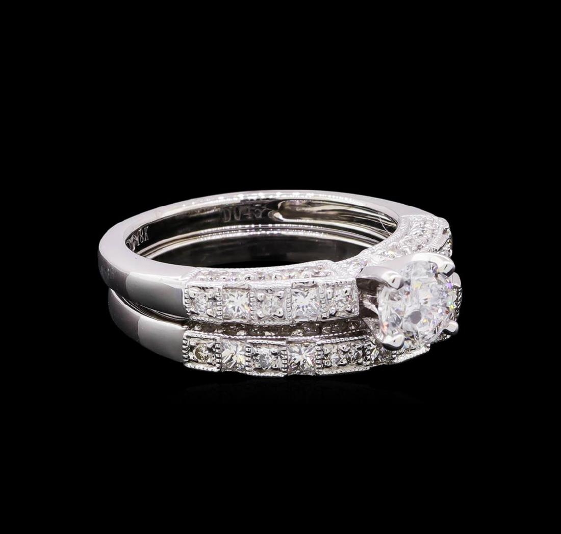 1.70 ctw Diamond Wedding Ring Set - 18KT White Gold: One electronically tested 18KT white gold ladies cast diamond wedding set. The wedding set includes a diamond engagement ring and a matching diamond wedding band. The engagement ring features a diamon