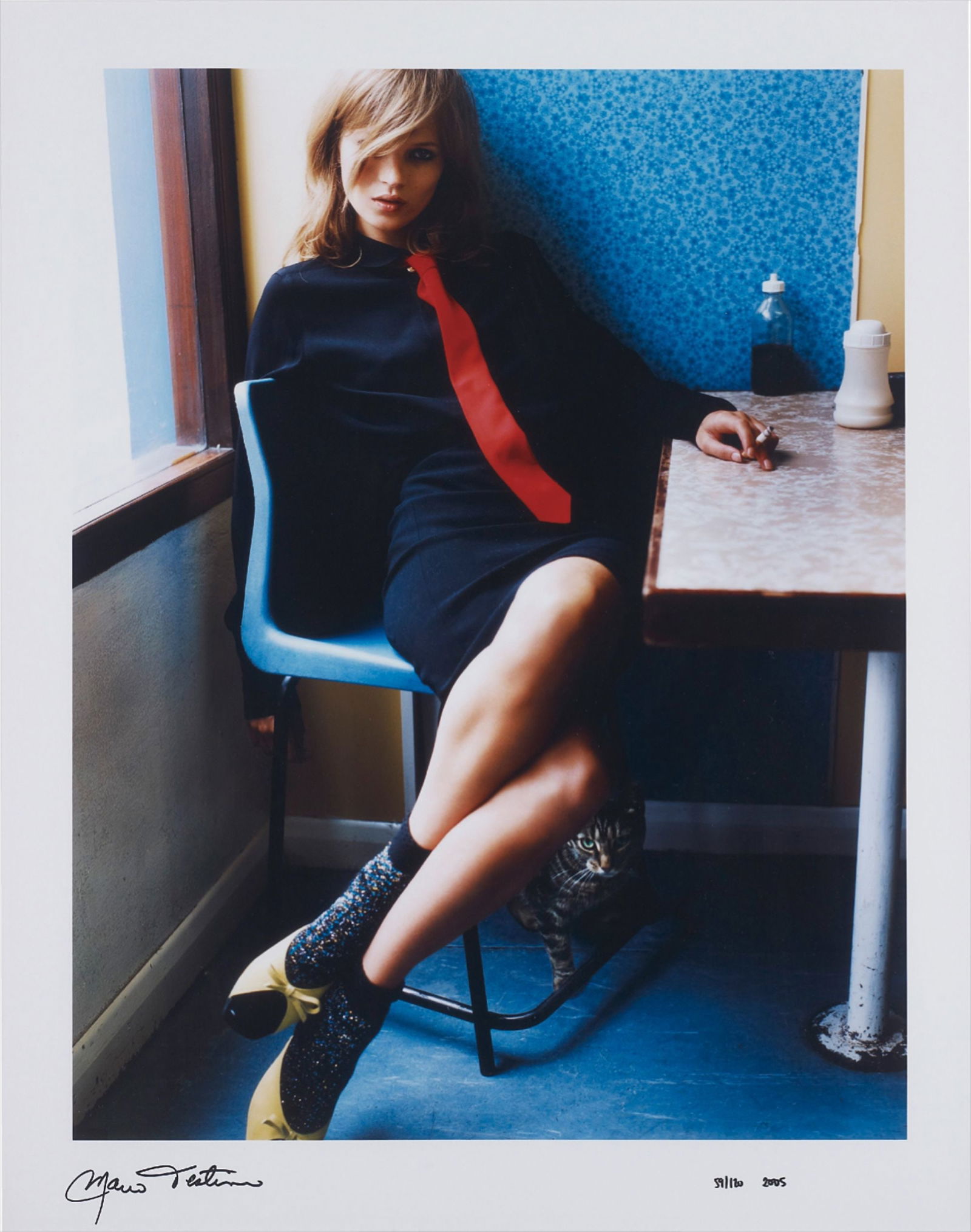 MARIO TESTINO KATE IN BLUE CAFE PRINT: Mario Testino Kate in Blue Cafe Photo Print mounted to conservation board measuring at 15.25x20.5 inches. Plate signed in the bottom left corner. Printed later.