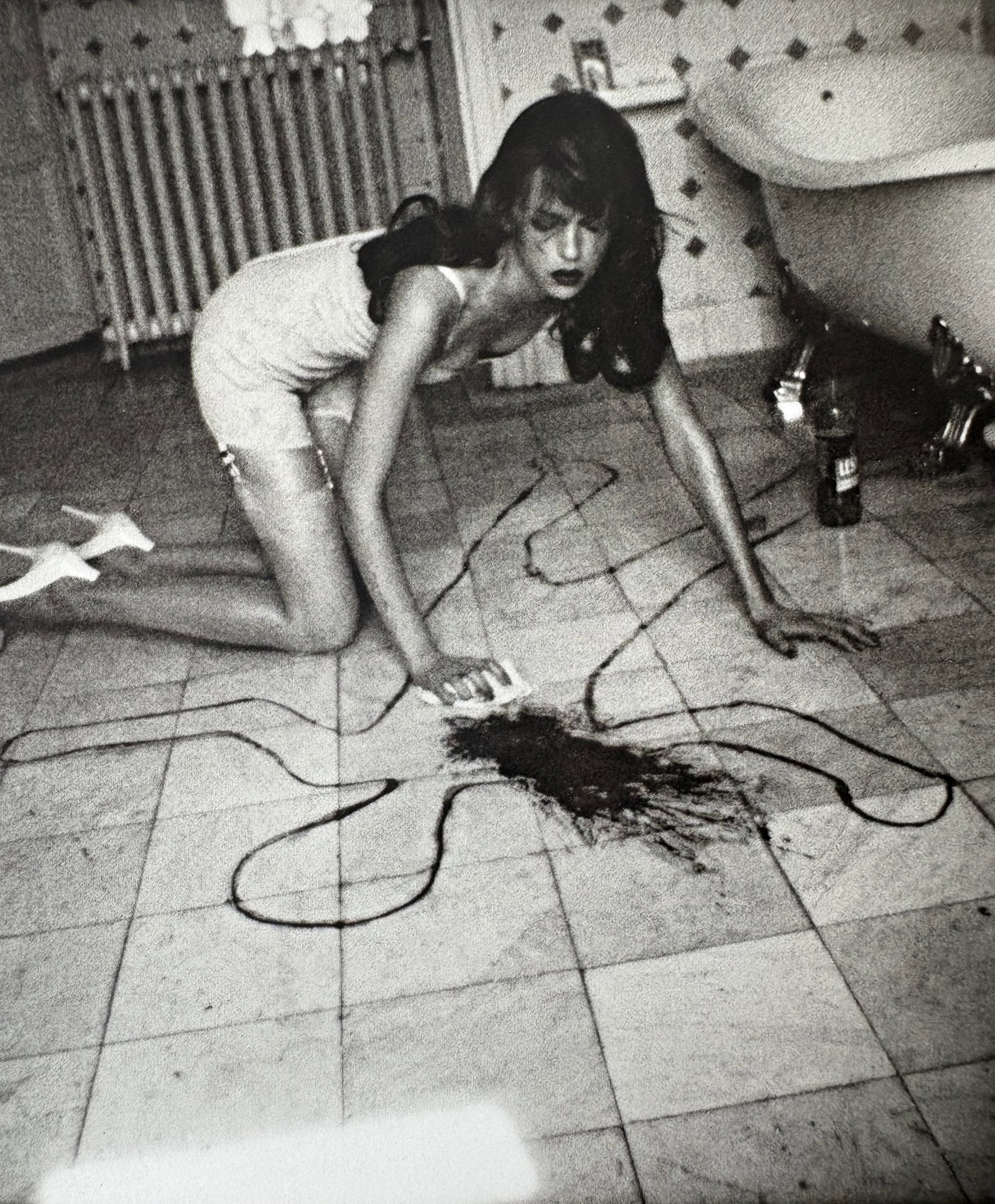 HELMUT NEWTON SPILL PRINT: Helmut Newton Spill Print mounted to board measuring at 5.25x6 inches