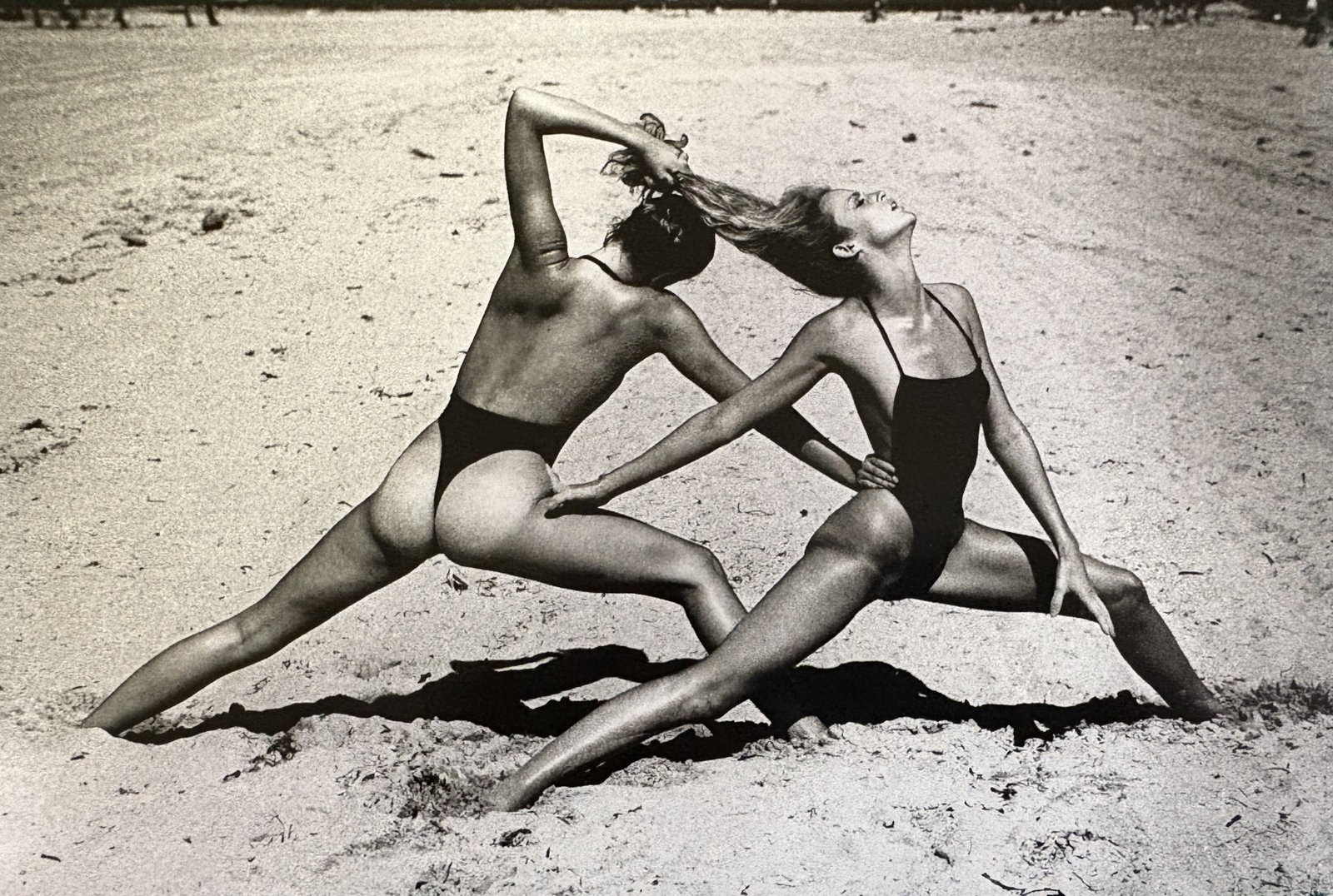 HELMUT NEWTON BEACH EXCERCISE DUOTONE PRINT: Helmut Newton Beach Excercise Duotone Print mounted to board measuring at 6.5x9.5 inches.