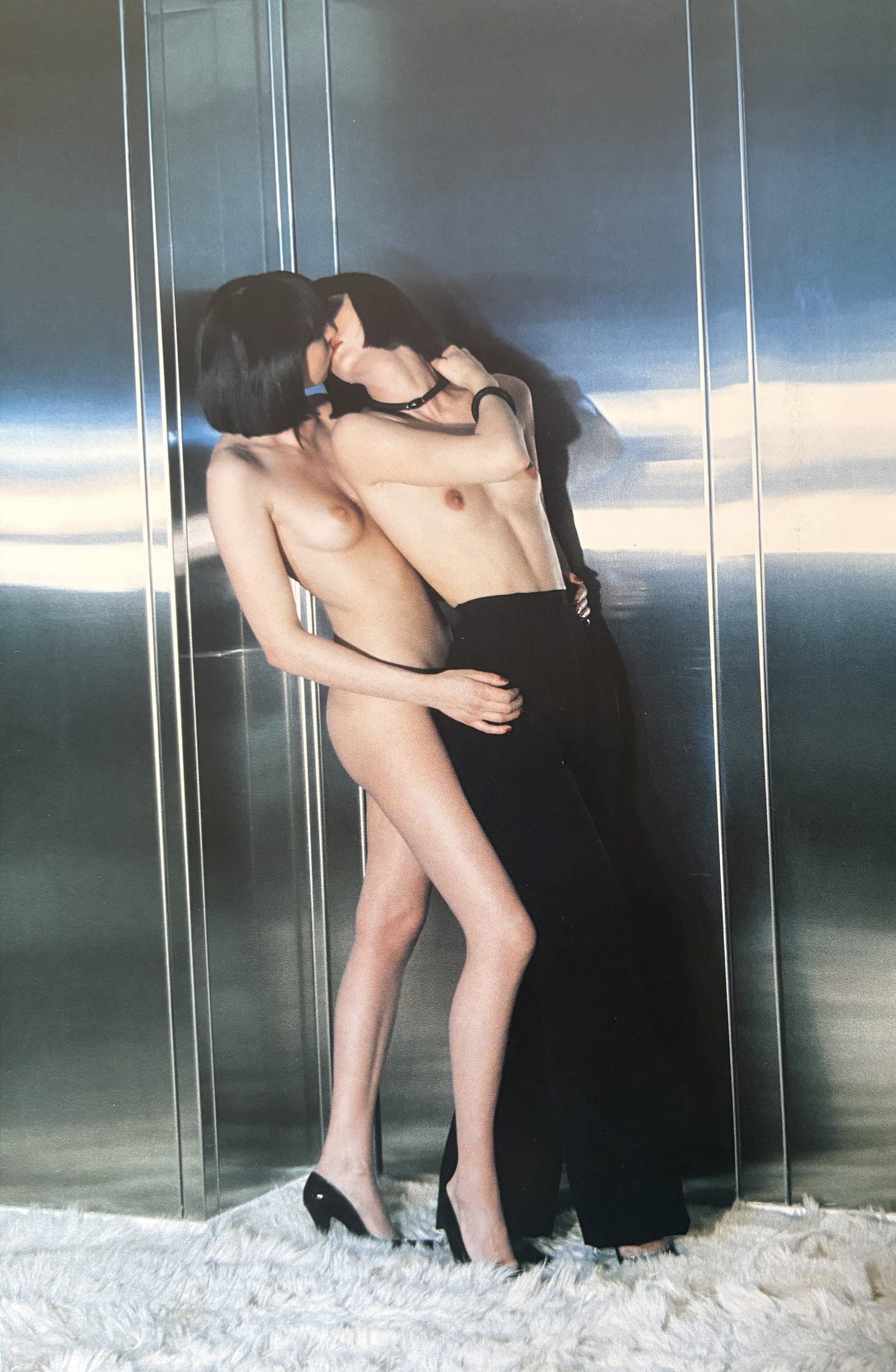 HELMUT NEWTON FEMALES KISSING DUOTONE PRINT: Helmut Newton Females Kissing Duotone Print professionally mounted to conservation board measuring at 7.25x11 inches.