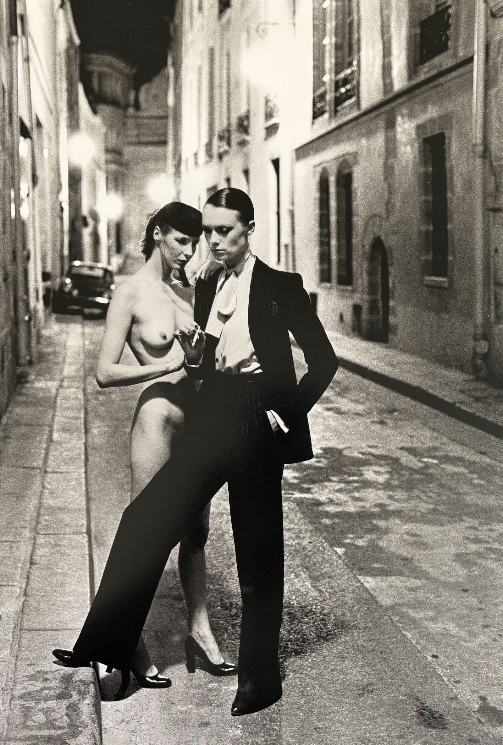 HELMUT NEWTON RUE AUBRIOT PHOTO LITHO: Helmut Newton Rue Aubriot Photo Litho mounted to board measuring at 9x14 inches.