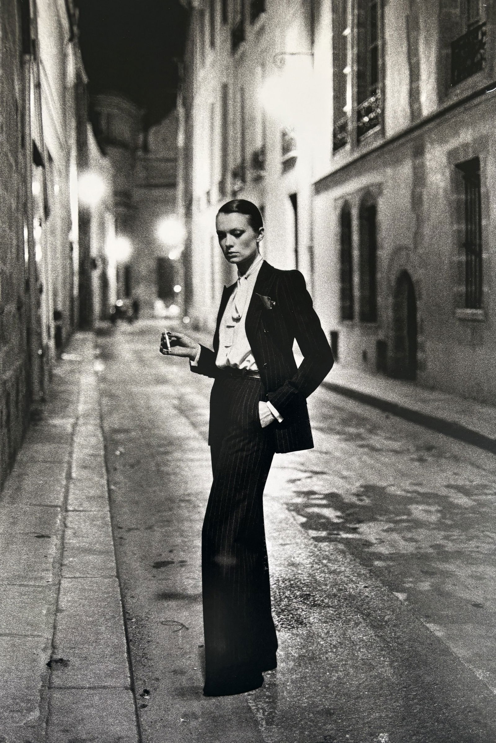 HELMUT NEWTON RUE AUBRIOT PHOTO LITHO: Helmut Newton Rue Aubriot Photo Litho mounted to board measuring at 9x14 inches.