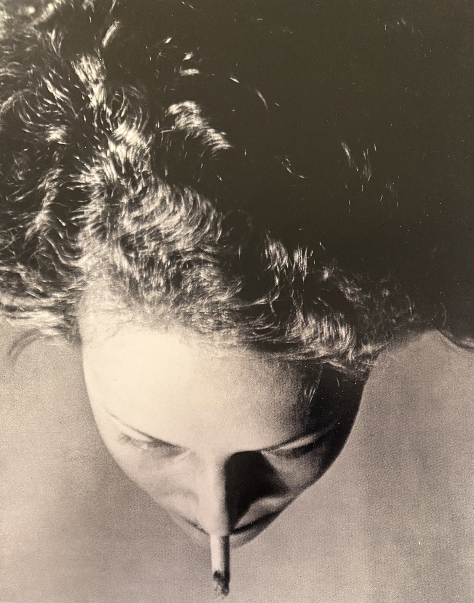 MAN RAY WOMAN WITH CIGARETTE PHOTO LITHO: Man Ray Woman with Cigarette Photo Litho mounted to board measuring at 6.25x8 inches.