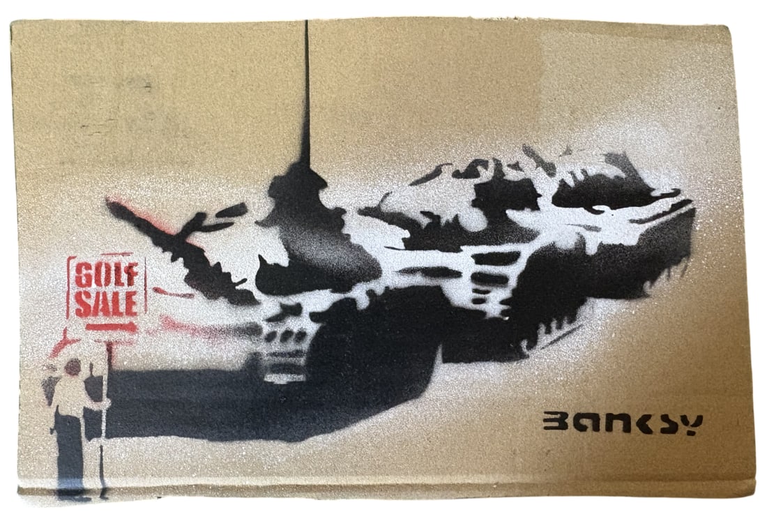 BANKSY TANK CARDBOARD STENCIL: Banksy Tank Cardboard Stencil measuring at 7x10 inches. Marker signed on the rear and numbered 6/20.