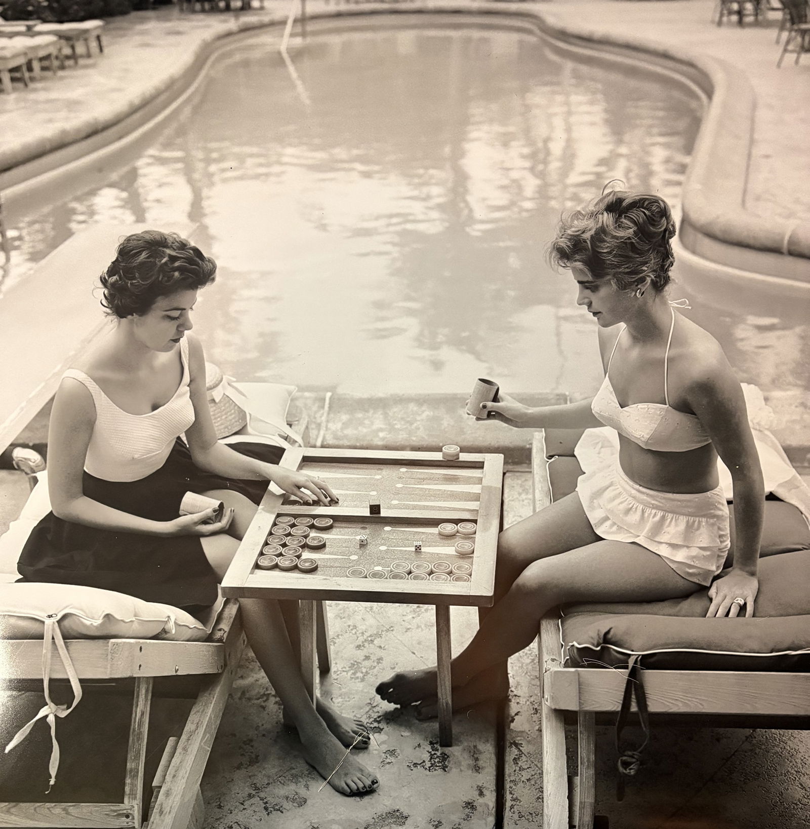 SLIM AARONS BACKGAMMON BY THE POOL PRINT: Slim Aarons Backgammon by the pool print measuring at 30x30 inches