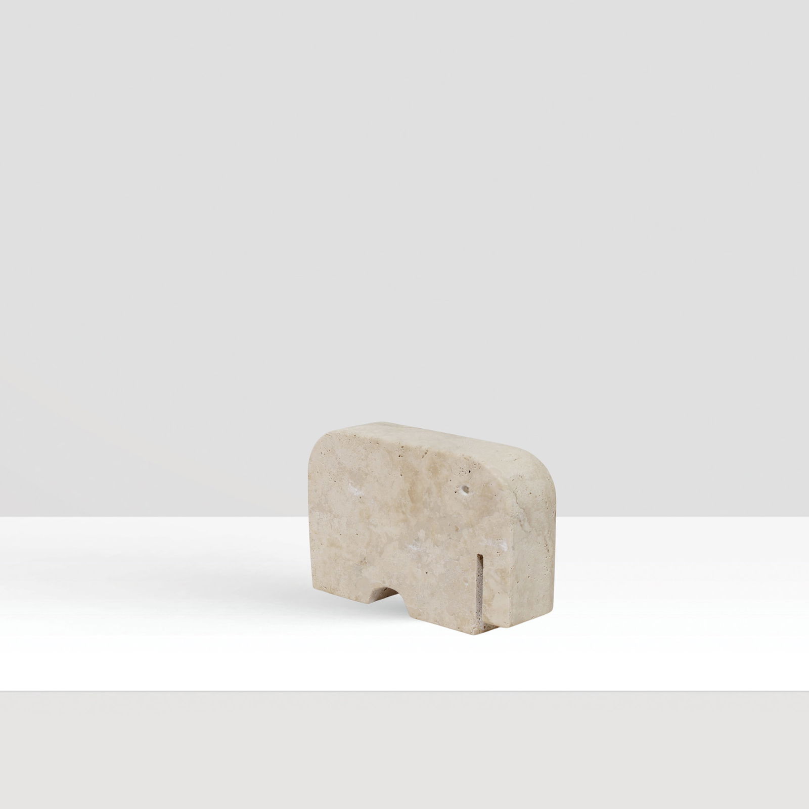 Enzo Mari prod. Fratelli Manelli Italy, 20th century 12x18x5 cm: travertine sculpture depicting an elephant.