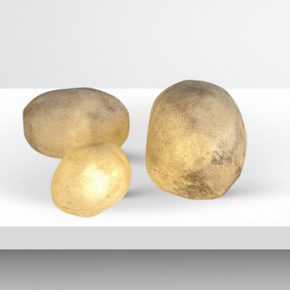 French manufacture 70s different measurements: set of three pebble-shaped luminous lamps in fiberglass and marble dust.