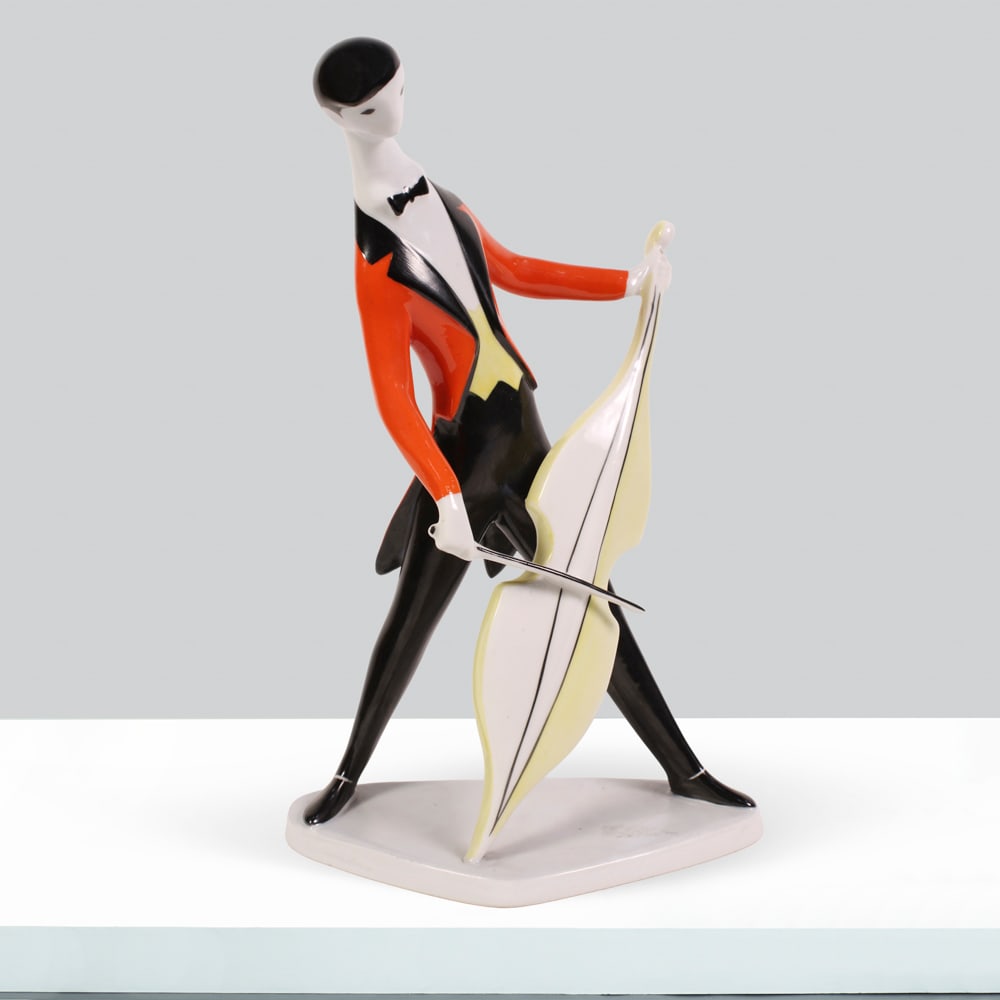 Zsolnay Manufacture Hungary, 20th century h. 23cm: porcelain figurine depicting a cellist.