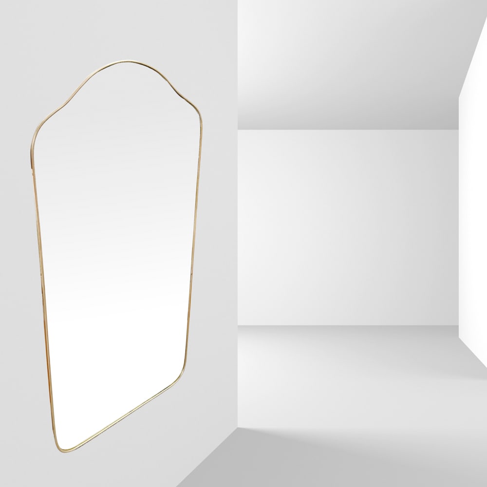 Gio Ponti, attributed Italy, 1960s 128x68 cm.: shaped wall mirror in brass and mirrored glass.