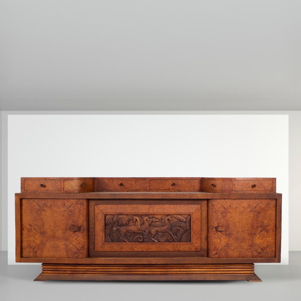 Pier Luigi Colli Italy, 1940s 99x243x56 cm: sideboard in wood, central section carved with animal figures, front with six drawers and two doors, key bearing the manufacturer?s mark.