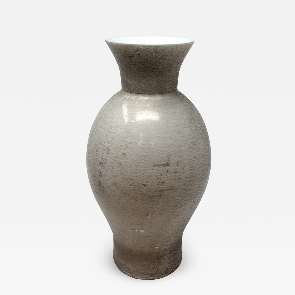 Venini Lucenti Classic Vase in Silver Grey: This beautiful Murano Glass vase is by the furnaces of Venini. It features a beautiful metallic finish that mixes various colors from light to dark silver. Signed and dated. Measures 13.5" tall x