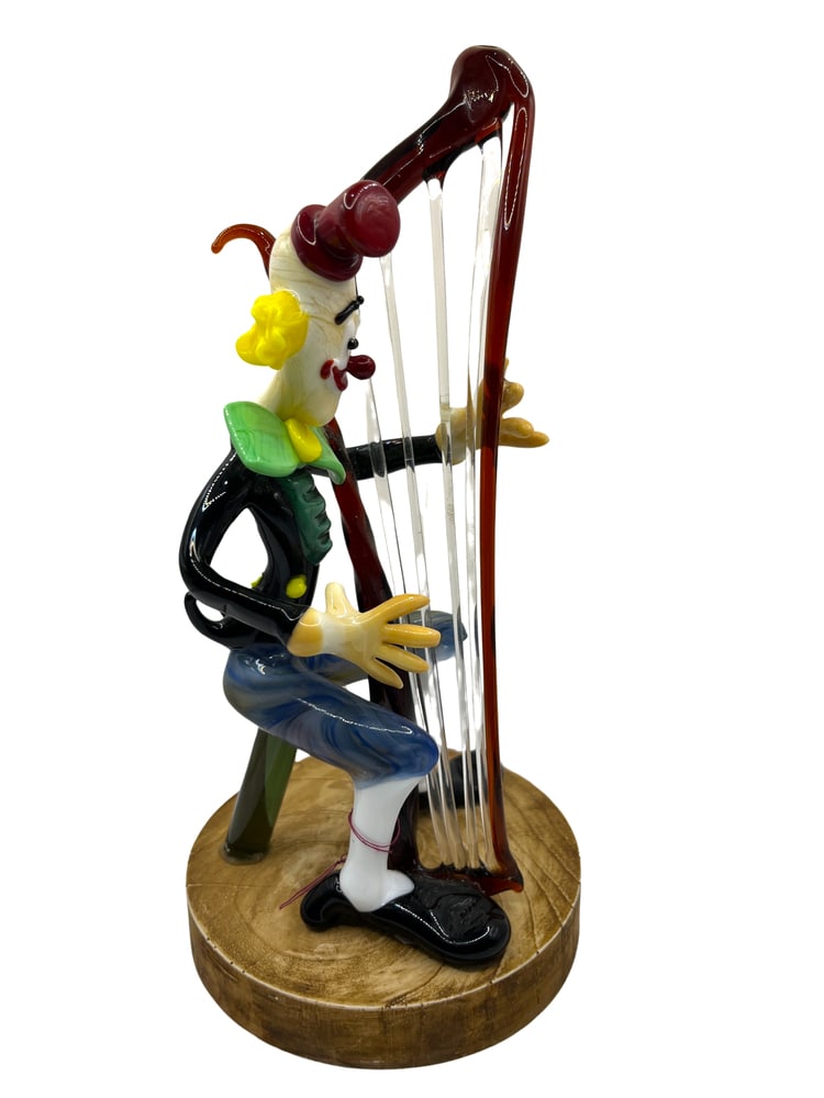 Murano Glass Clown with Harp: Murano Glass Clown Figurine by Renowned Glass Master Tommasi. Add a touch of whimsy and elegance to your home decor with this exquisite Murano glass clown figurine, expertly crafted by one of the