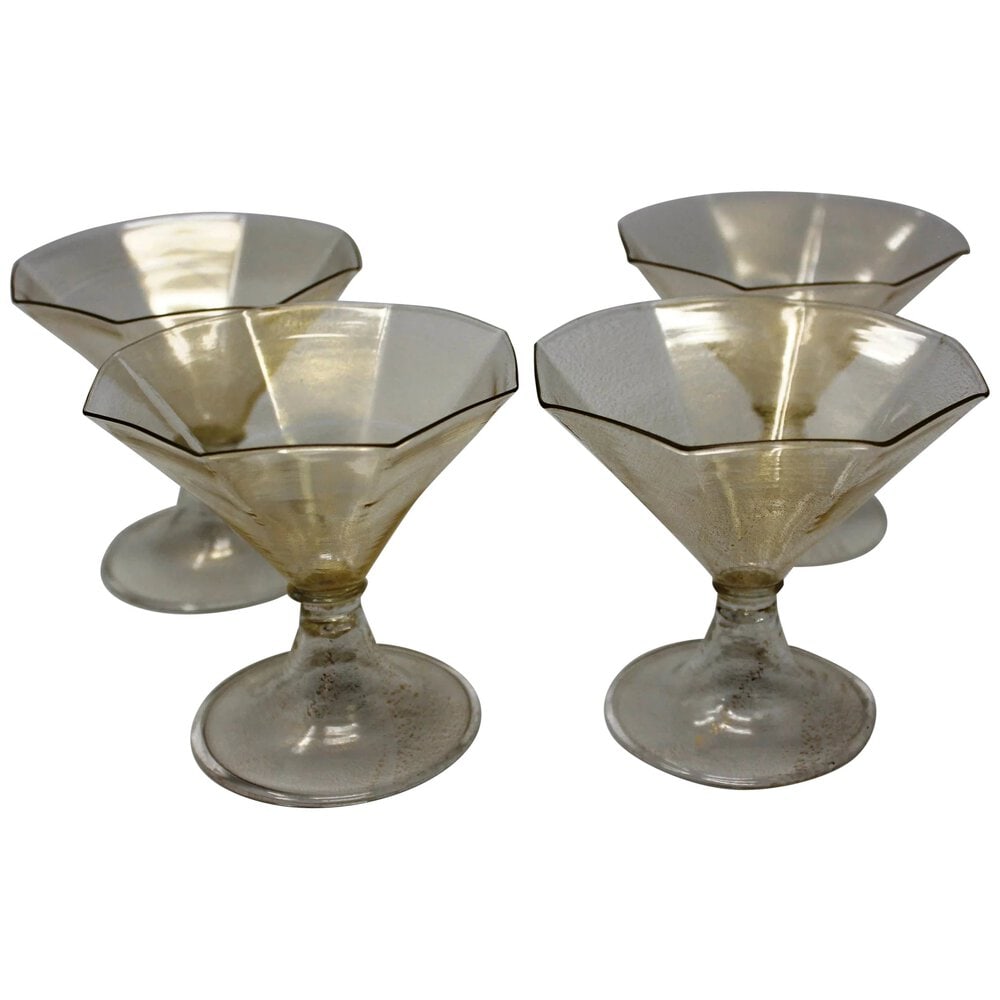 Set of 6 Murano Glass Gold Sorbets: Vintage sorbets made of 24K gold infused Murano Glass. 4 inches tall. Set of 6. Circa 1960s. Very good condition. Dimensions: 4.5"W x 4.5"D x 4.5" H.