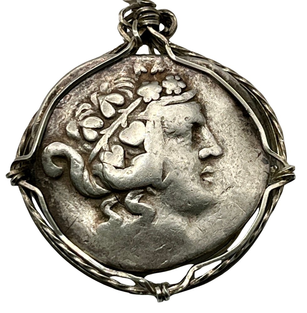 Hercules and Dionysus Greek Coin Pendant: Acquire a piece of ancient history with this genuine Greek coin, featuring Hercules and Dionysus, God of wine, masterfully converted into an exquisite pendant necklace. (#90B)Highlights:- Authentic
