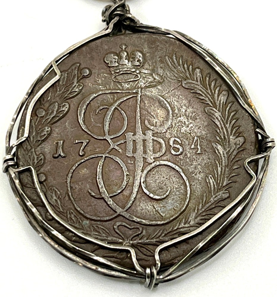 Russian 5 Kopek Dated 1784 Coin Pendant: Acquire a fragment of history with this genuine bronze coin, a Russian Kopeks coin dated 1784, masterfully converted into an exquisite pendant necklace. (#287)Highlights:- Authentic ancient bronze coi