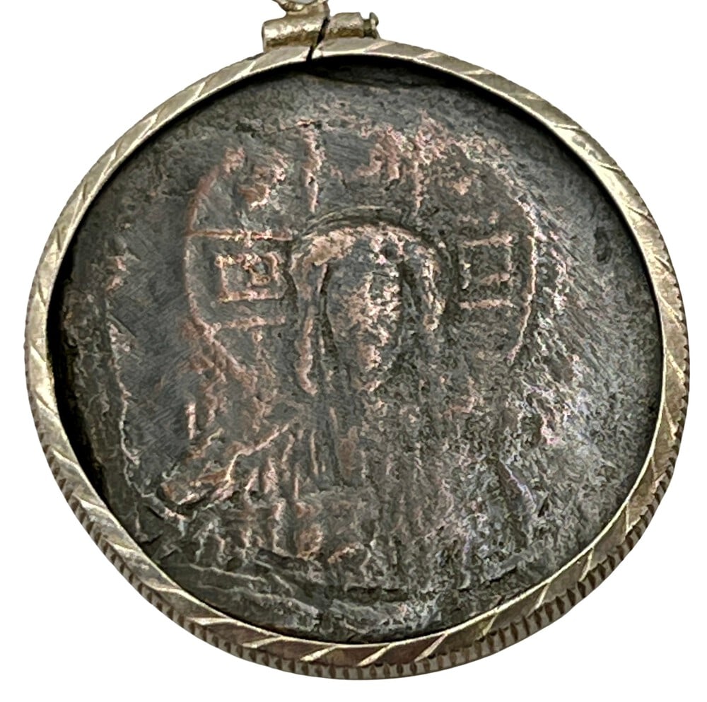 Jesus, King of Kings Coin Pendant: Acquire a piece of ancient history with this genuine bronze coin, the earliest known to bear the likeness of Jesus Christ, masterfully converted into an exquisite pendant necklace. (#216)Highlights:- 