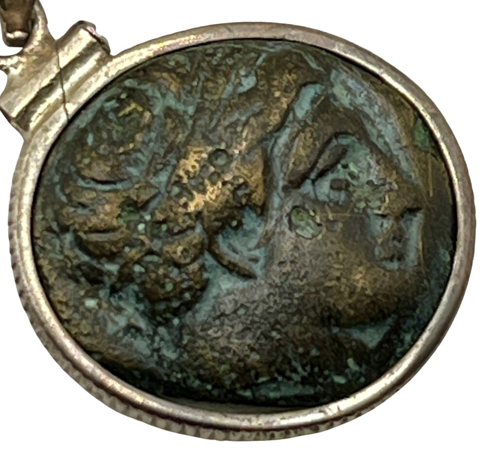 Ancient Coin of Apollo and Horse: Acquire a fragment of ancient history with this genuine bronze coin, featuring Apollo and a Horse, masterfully converted into an exquisite pendant necklace. (#238). - Authentic ancient bronze coin (ci