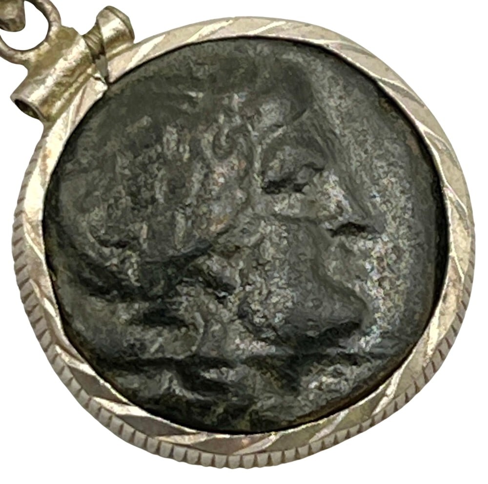 Ancient Apollo Coin from Greece: Greek Coin of Apollo, expertly transformed into a stunning pendant necklace. (#298). Genuine ancient bronze coin (circa 340 BCE). Beautifully mounted in a pendant setting, showcasing the coin’s intr