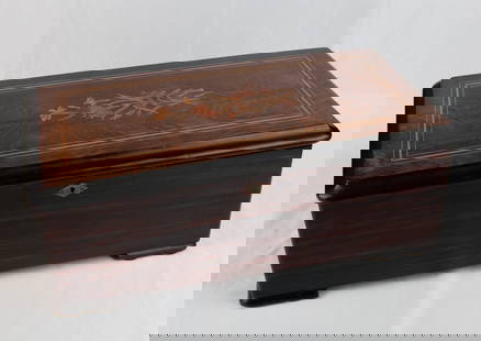 Picard-Lion (Geneva, Switzerland) music box with brass movement: Era: Late 19th centuryStyle: Charles X styleMaterial: Mahogany, precious wood, ebony, brassDimensions: 18 × 46 × 25 cmPlace of Origin: Picard-Lion Music Box Workshop, Geneva, SwitzerlandDescription: