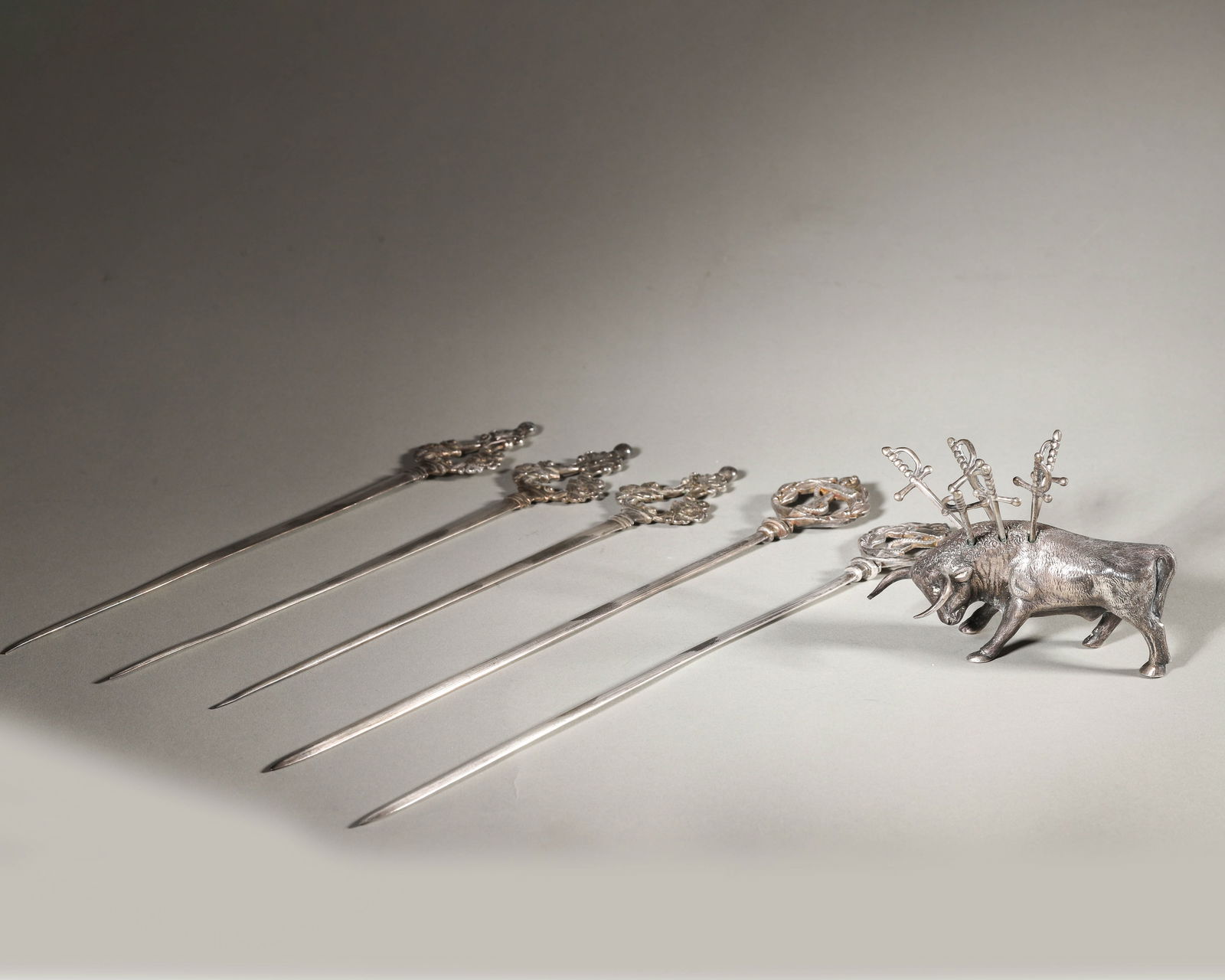 A Spanish Silver Novelty Bull Shaped Fruit or Olive Fork and a set of silver plated meat forks (1 of 8)