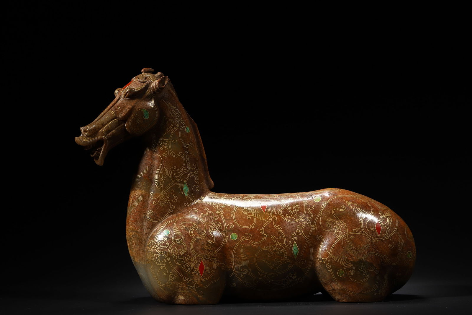Han Dynasty Jade Gold-Inlaid Gemstone Recumbent Horse Ornament: Length 32.0cm (12.6in), Width 10.0cm (3.94in), Height 21.0cm (8.27in), Weight 5823.0g (12.84lb)Hetian jade carved into a horse shape, gold inlays of cloud patterns, inlaid with turquoise and gemstones