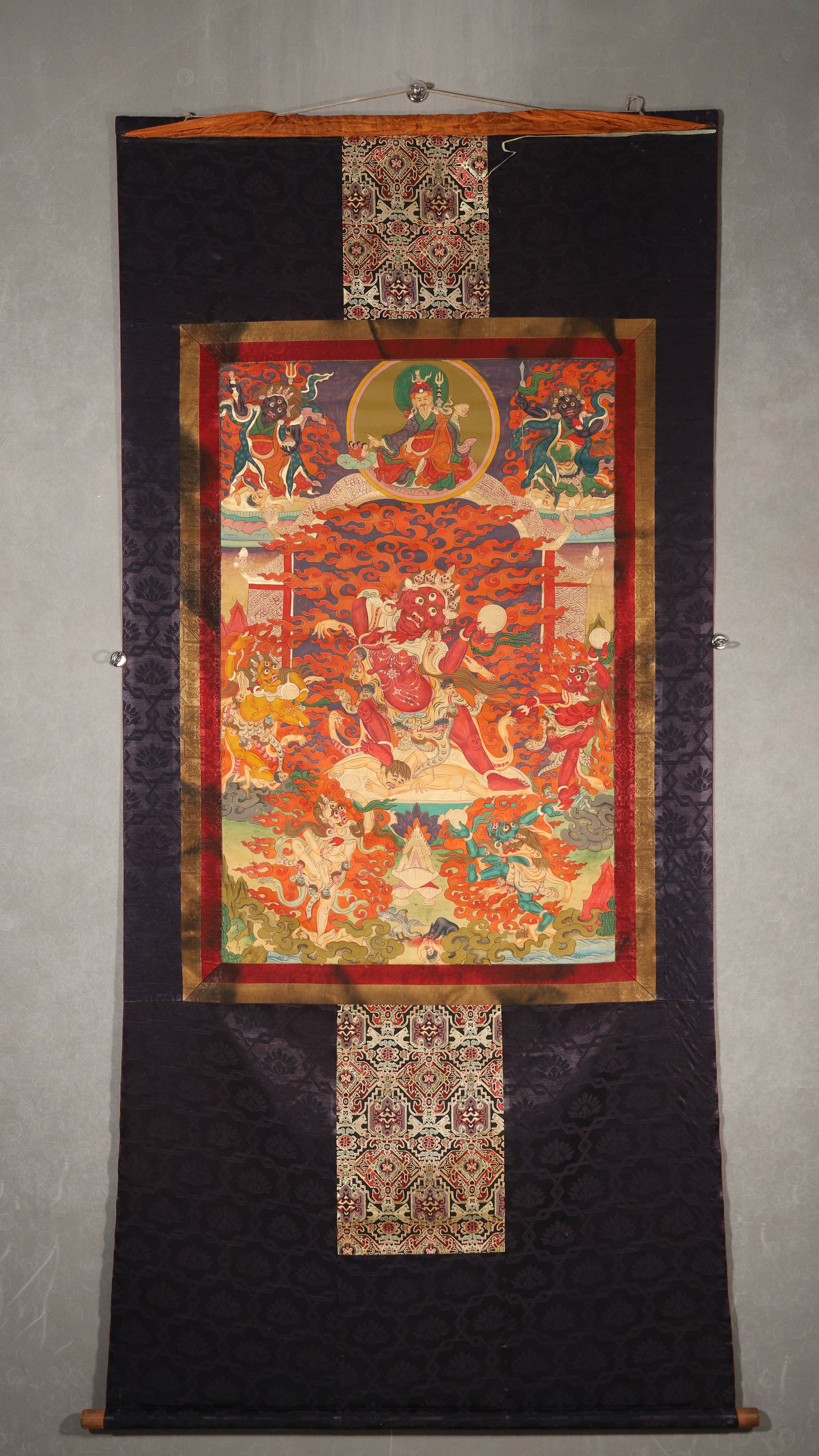 18th Century Tibetan Thangka of Dharma Protector: Length 89cm Width 58cm (Length 35.04" Width 22.83")18th-century protector-deity thangka: wrathful deity (flame aura) + retinue; dynamic composition; bold, layered mineral pigments. Traditional brocade