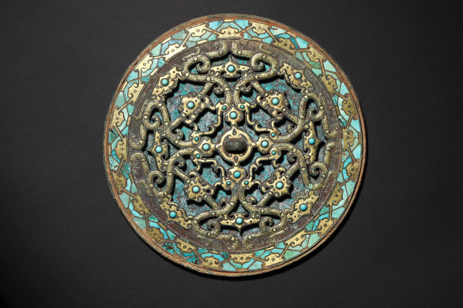 Han Dynasty Gold-and-Silver-Inlaid Turquoise Openwork Bronze Mirror: Diameter 17.0cm (6.69in), Weight 1003.0g (2.21lb)Inlaid Gold with Openwork Coiled Dragon Patterns, Adorned with Turquoise; Combining Openwork, Cuo-Jin & Inlay. A High-Rank Aristocratic Vessel of the H