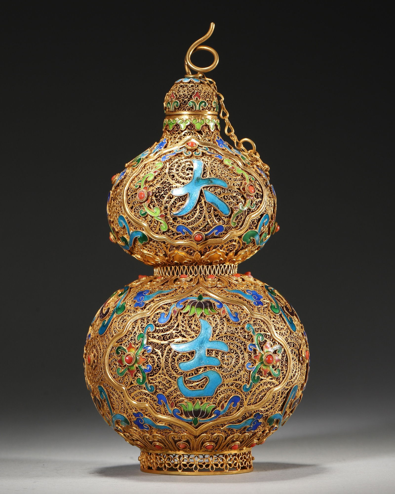 Qing Dynasty, Qianlong Period, Silver-Gilt Gourd-Shaped Vase with Filigree and Cloisonné Enamel,: Diameter 9.0cm (3.54in), Height 18.0cm (7.09in), Weight 269.0g (0.59lb)With a base woven from fine silver threads, gilded, filled with blue enamel and inlaid with gemstones. The vessel body is decorat