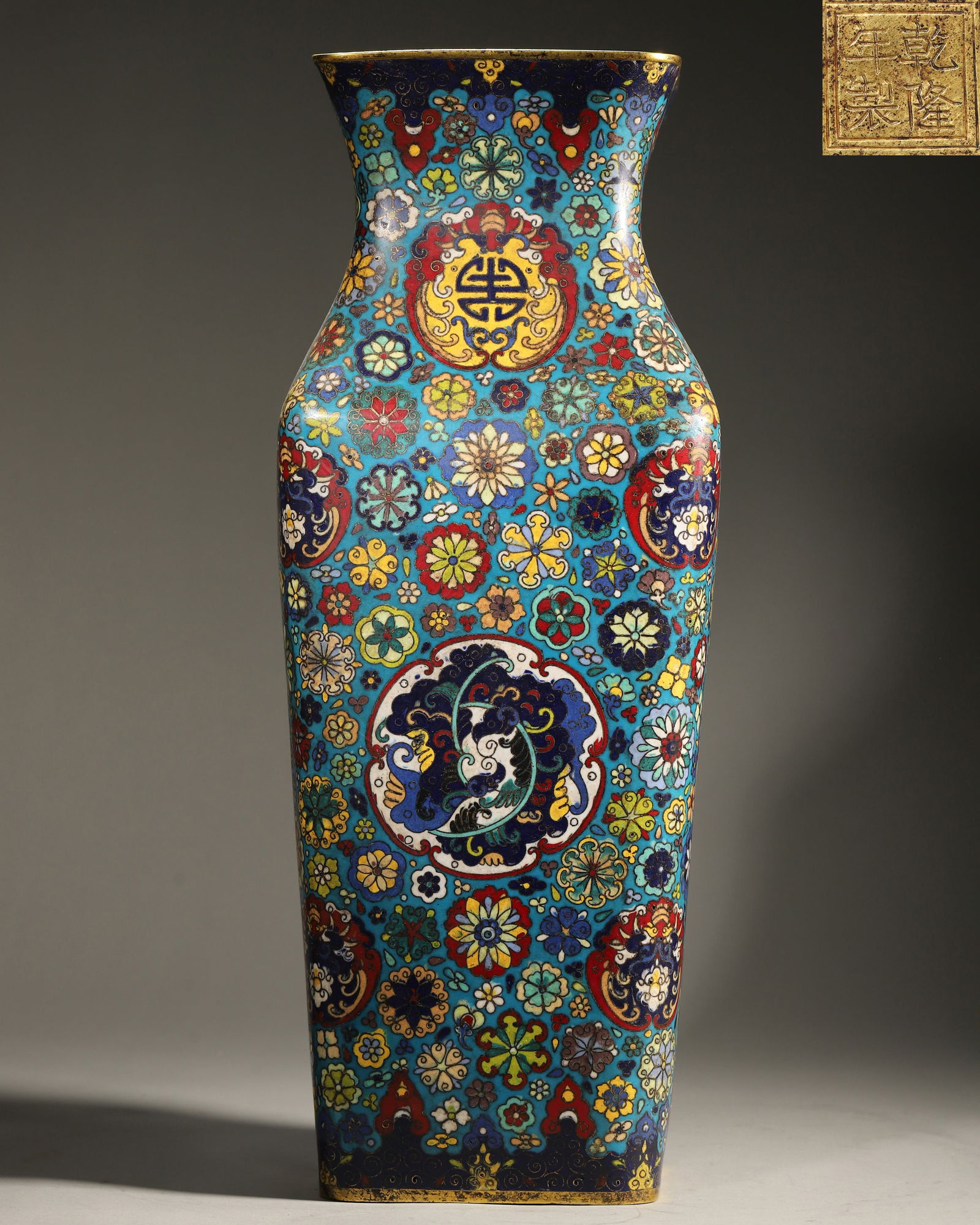 Qing Dynasty, Qianlong Mark, Cloisonné Enamel on Copper Rectangular Vase: Width 18.0cm (7.09in), Height 47.5cm (18.7in), Weight 4883.0g (10.77lb)Made by the Imperial Workshop. The vase body is fully decorated with hundreds of flowers pattern, longevity characters, and