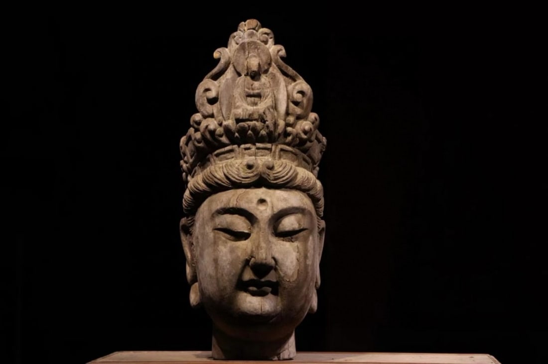 Tang Dynasty: Polychrome Wood Head of Avalokiteshvara: Height: 56cm (Height: 22.05"); Width: 25cm (Width: 9.84")This Tang Dynasty wood carved Guanyin head (Tang Buddhist masterpiece): crowned figure, plump "compassionate smile," spiral hair, flowing robes