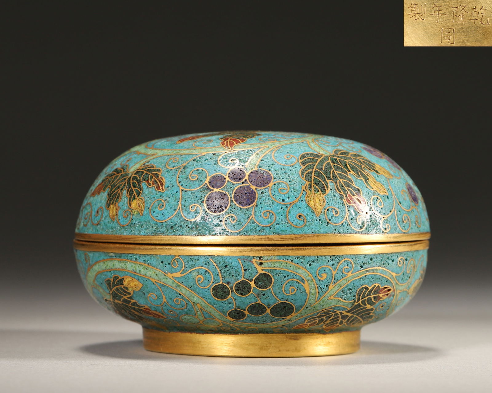 Qing Dynasty, Qianlong Mark, Cloisonné Enamel on Copper Hand Box with Grape Vine Pattern: Diameter 8.5cm (3.35in), Height 5.0cm (1.97in), Weight 259.0g (0.57lb)Imperially made by the Imperial Workshop. The box body uses blue as the background, with wire inlay outlining grape branches and