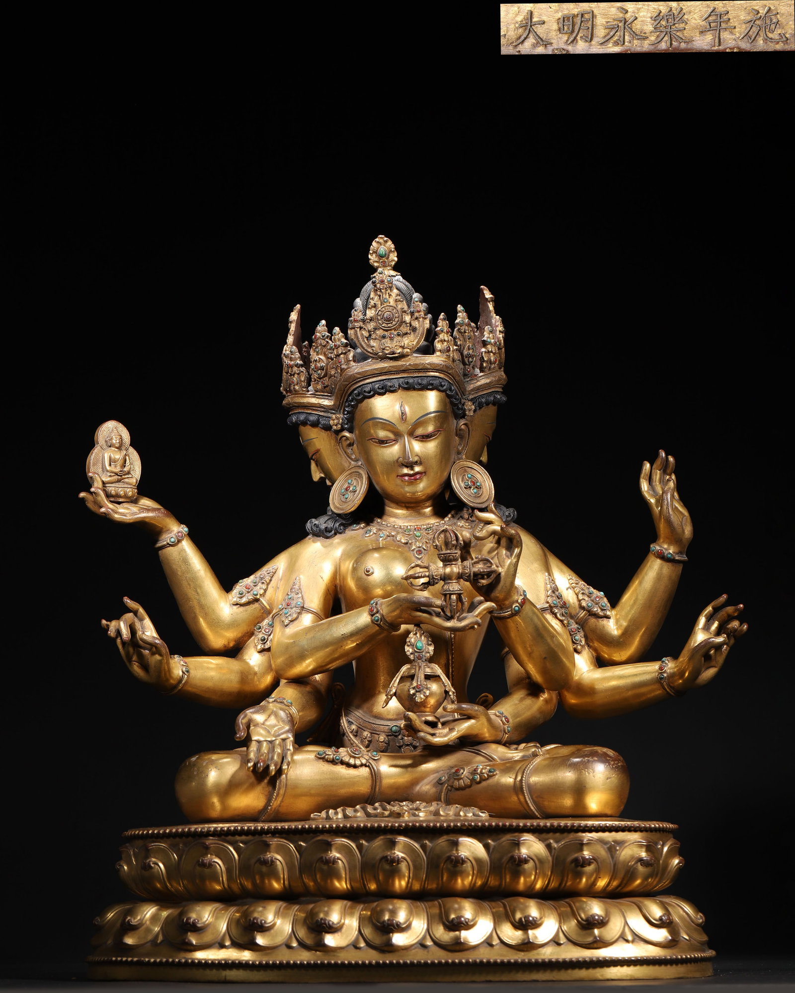Yongle Period, Ming Dynasty Gilt Bronze Seated Ushnishavijaya (Three-Faced, Eight-Armed): Length (L): 40.0cm (15.75in); Width (W): 26.0cm (10.24in); Height (H): 48.0cm (18.9in); Weight (Wt): 14.8kg (14800.0g) (32.63lb)An imperial gilt bronze figure of Ushnishavijaya from the Yongle Period,