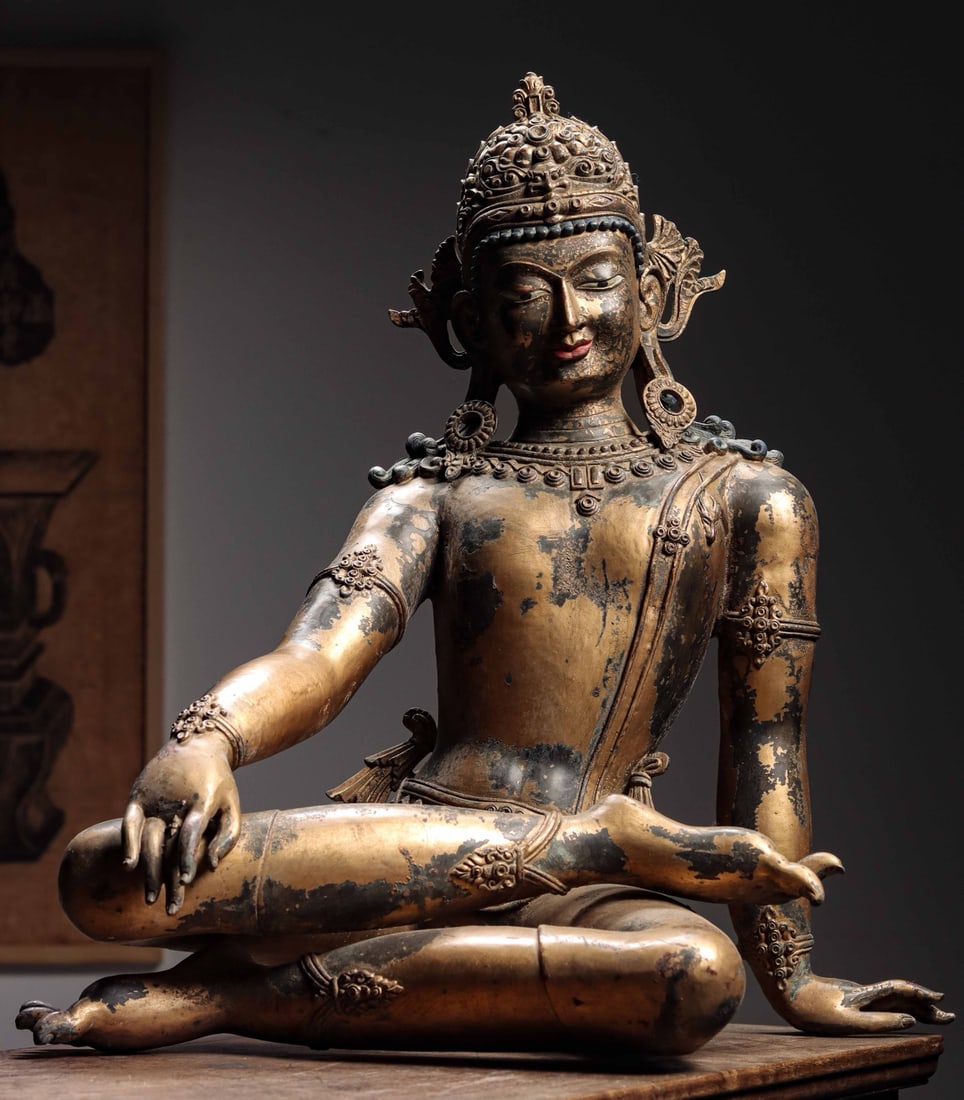 Ming Dynasty, Gilt Bronze Seated Guanyin in Ease Pose: Weight: 20950g (46.19 lb) | H: 62cm (24.41 in) | W: 55cm (21.65 in) | D: 38cm (14.96 in)A fine gilt bronze figure of Guanyin from the mid Ming Dynasty, blending Han and Tibetan styles. With a relaxed,