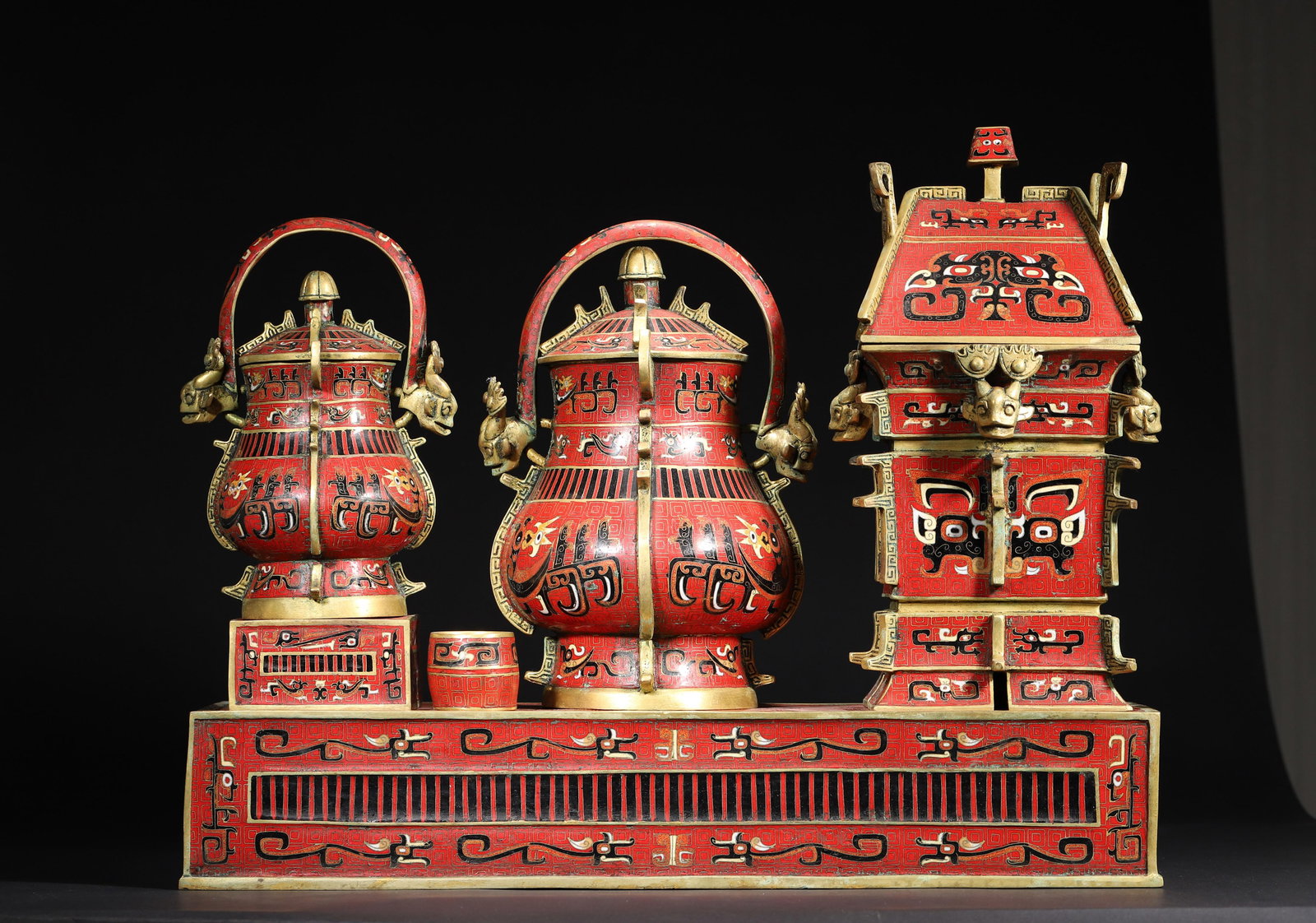 Qing Qianlong Period Cloisonné Archaistic Wine Vessel Set: Length (L): 50.0cm (19.69in); Width (W): 16.0cm (6.3in); Height (H): 40.0cm (15.75in)Qing Qianlong imperial cloisonné wine vessel set, archaistic Shang-Zhou style, red-ground cloisonné with beast mo