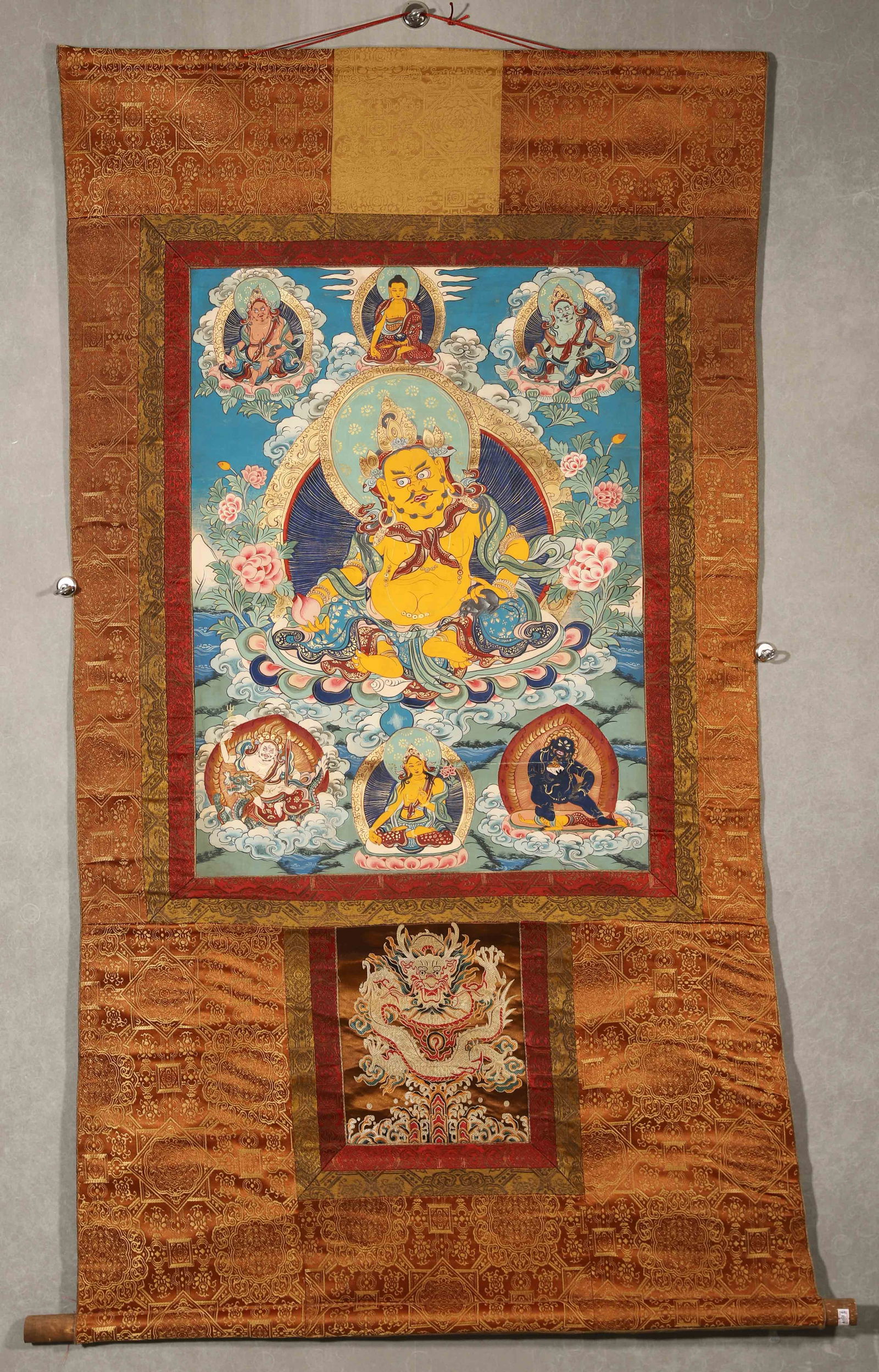 Mid-Qing Dynasty, Mineral Pigment Thangka of Yellow Jambhala: Length (L): 71.0cm (27.95in); Width (W): 53.0cm (20.87in)This mid-Qing Dynasty thangka depicts Yellow Jambhala and the Five Jambhalas with natural mineral pigments, featuring exquisite craftsmanship,