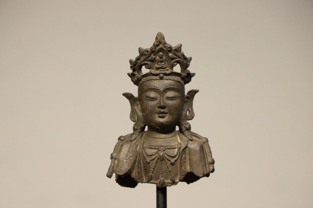 A FINE BRONZE BUST OF GUANYIN, MING DYNASTY, 15TH–17TH CENTURY AD: Height: 6.69" inches (17.0 cm) | Width: 4.72" inches (12.0 cm)This fine bronze bust of the Bodhisattva Guanyin from the Ming Dynasty, having withstood centuries of history, is exquisitely cast via the