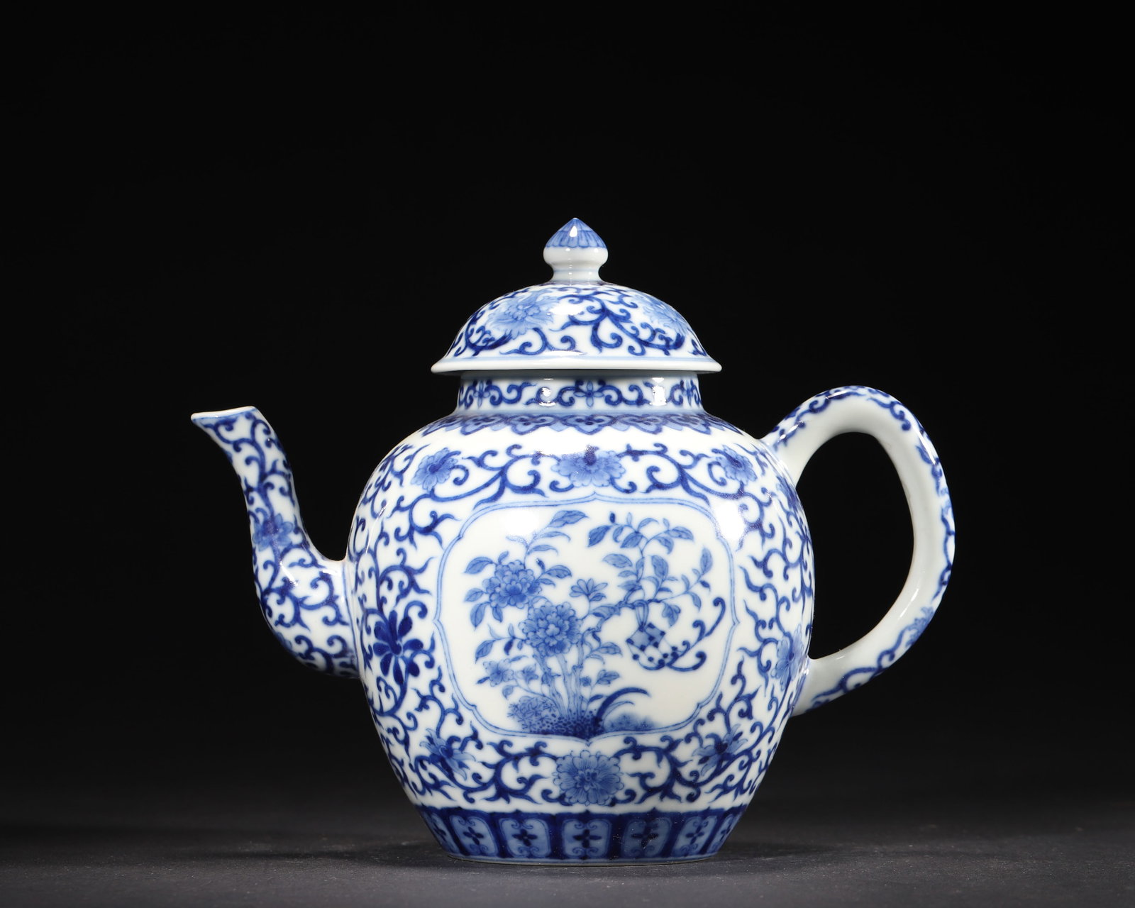 QIANLONG Period, QING Dynasty - Blue and White Teapot with Interlocking Birds and Flowers: 8.62" x 6.75" (22.0cm x 17.0cm). An imperial tea vessel from the Qianlong period of the Qing Dynasty, featuring vivid blue and white interlocking flower patterns and intricate bird-and-flower painting