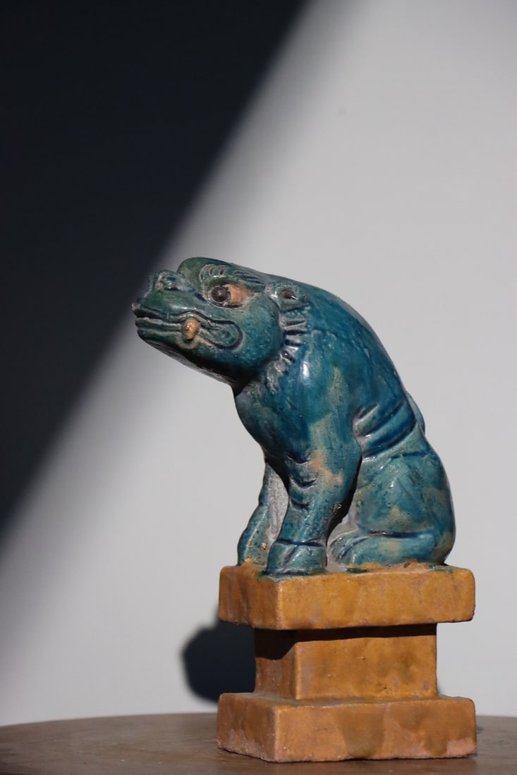 A TURQUOISE-GLAZED POTTERY FIGURE OF AN AUSPICIOUS BEAST ON STAND, MING DYNASTY: 3.94" x 2.76" x 9.06" inches (10.0 cm x 7.0 cm x 23.0 cm)The glaze is pure and lustrous, the form is majestic and imposing, and the craftsmanship is exquisite. The piece is in excellent overall condit