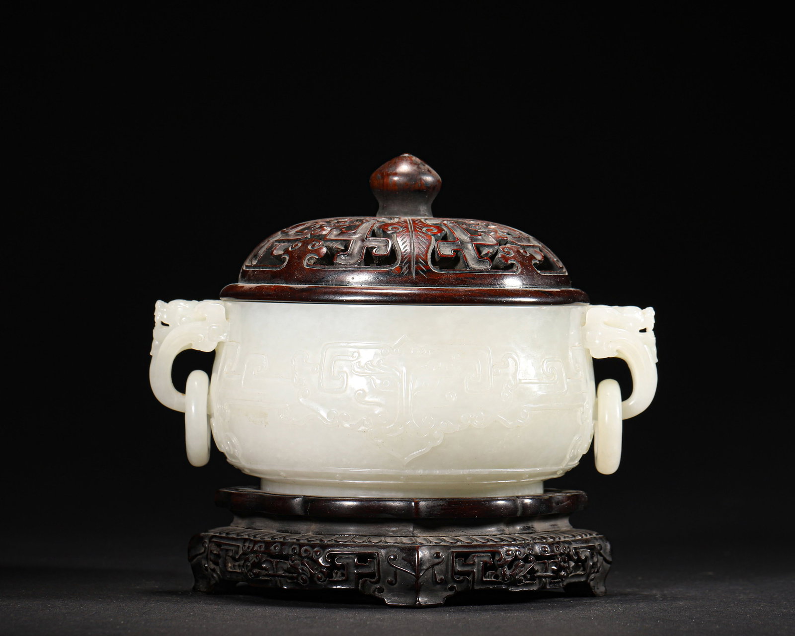 QING DYNASTY, WHITE HETIAN JADE CENSER WITH KUI-DRAGON PATTERNS, BEAST EARS AND RING HANDLES (WITH: 6.25" x 4.88" x 5.88" (16.0cm x 12.5cm x 15.0cm) | 1.70lbA Qing Dynasty imperial-style scholar's desk incense burner, carved from white Hetian jade with low-relief kui-dragon patterns, featuring vivid