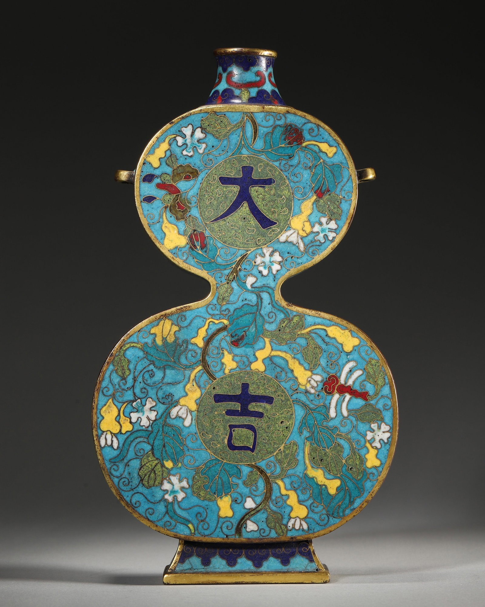 A FINE IMPERIAL GILT-BRONZE CLOISONNÉ ENAMEL 'DAJI' DOUBLE-GOURD VASE: 5.12" x 1.57" x 9.06" (13cm x 4cm x 23cm) | 2.17 lbs (986g)A fine imperial gilt-bronze cloisonné enamel 'daji' double-gourd vase, Qianlong mark and period, decorated with gourd vines and emblems, of